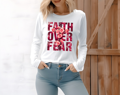On the front of this Christian vintage long sleeve shirt are the words Faith Over Fear in large block letters with a cross made of thorns in the middle that is covered in roses.