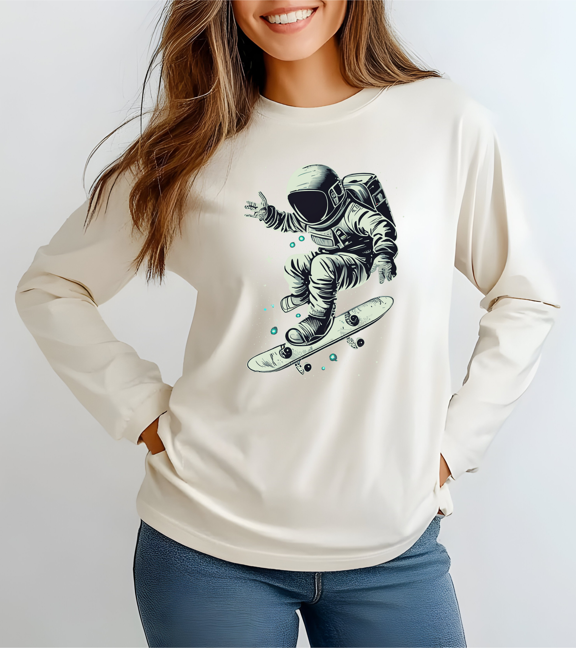 On the front of this custom unisex long sleeve shirt is an image of an astronaut riding a skateboard, there are a bunch of stars around the astronaut.