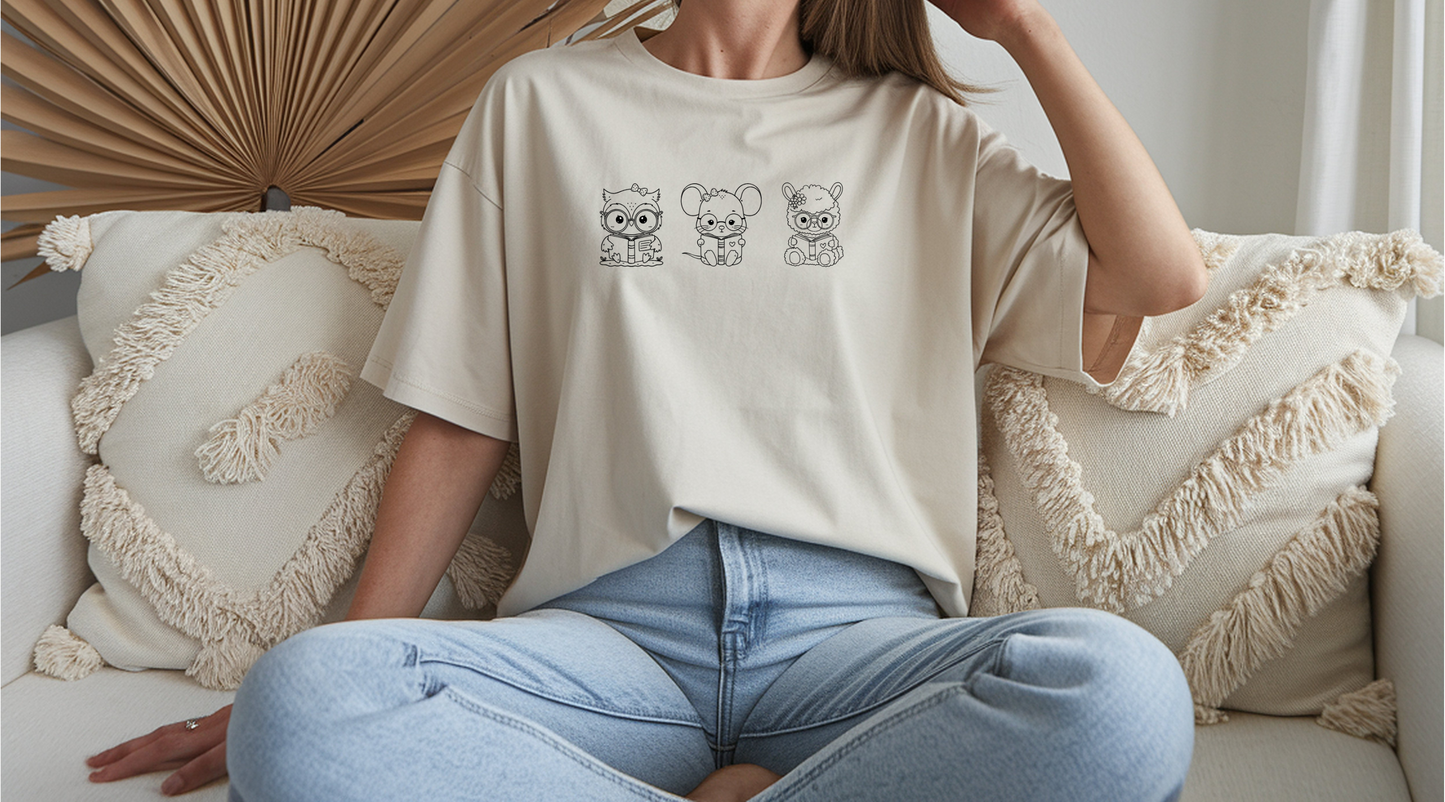 On the front of this custom women's shirt are three baby farm animals with the first being a baby owl then a baby mouse and the last one is a baby lamb, all three of the animals have glasses on and are reading books.