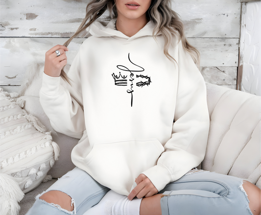 This custom unisex Christian hoodie features the name of Jesus in a cursive font down the center of the front of the sweater, there is an image of a crown on the right and a crown of thorns on the left of the name of Jesus.