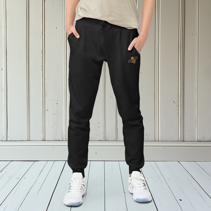 A pair of super soft fleece unisex sweatpants with a bumble bee embroidered in gold over the left front pocket of the pants.
