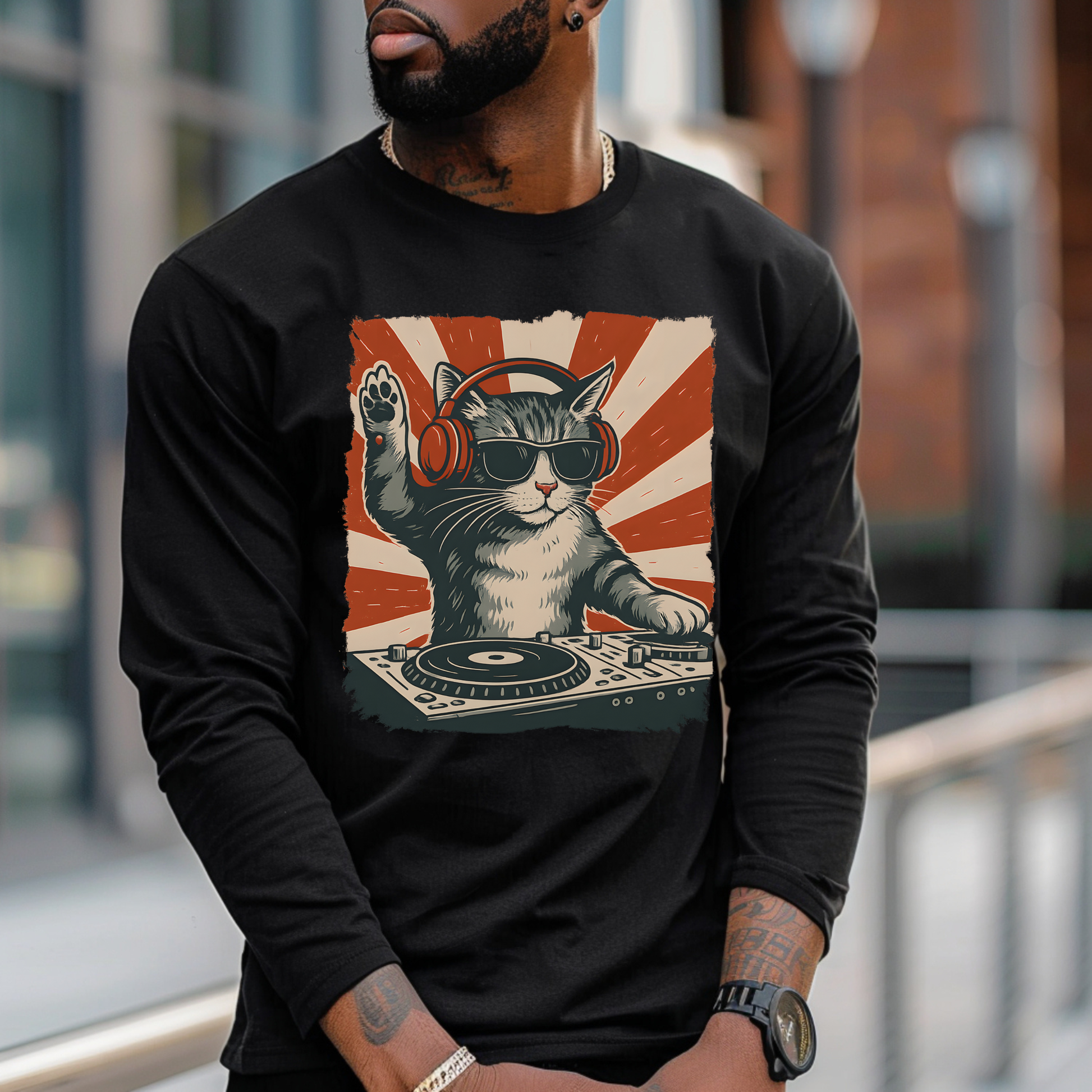 On the front of this custom retro long sleeve shirt is a DJ playing music, except the DJ is a cat that is wearing headphones, there is a vintage red and ivory background behind the cat.