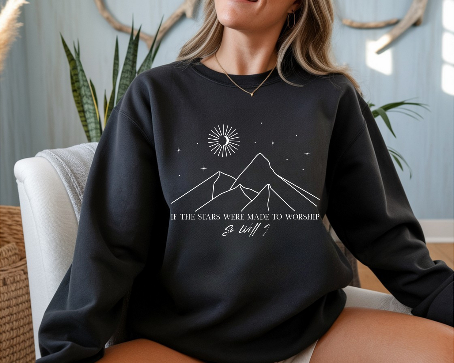 On the front of this Christian sweater is an image of mountains with a bunch of stars on the top, the words If the stars were made to worship So will i in two different fonts.