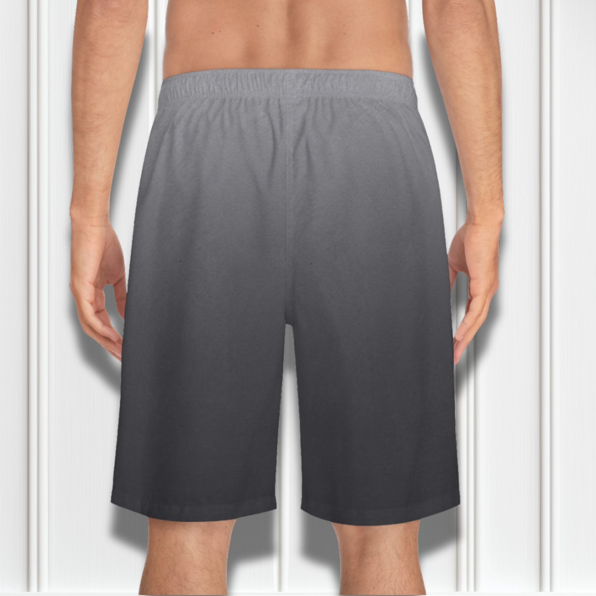 These custom men's board shorts feature a unique design with a ombre pattern starting with a light grey at the top then fading to a dark grey at the bottom, there is a symbol of a dove carrying a fig leaf on the front left side of the shorts just at the knee.