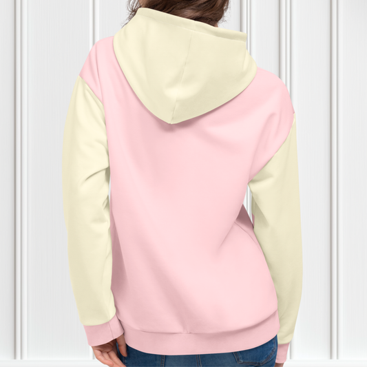 A custom women's color block hoodie with the front and the back of the hoodie being a light pastel pink, the front pocket, both sleeves and the hood are a light ivory in color.