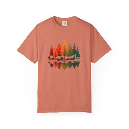 On the front of this custom comfort colors short sleeve shirt is a image of trees in the fall time with all the different fall colors, the trees reflection is right underneath making them look like they are above water.