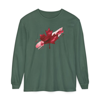 On the front of this unisex long sleeve shirt is an image of a Canadian maple leaf that is bright red, it looks like it has been spray painted onto the front of the shirt.
