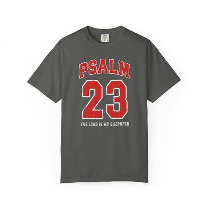 On the front side of this custom vintage t-shirt are the words Psalm 23 The Lord Is My Shepherd, it is with red and white block lettering.