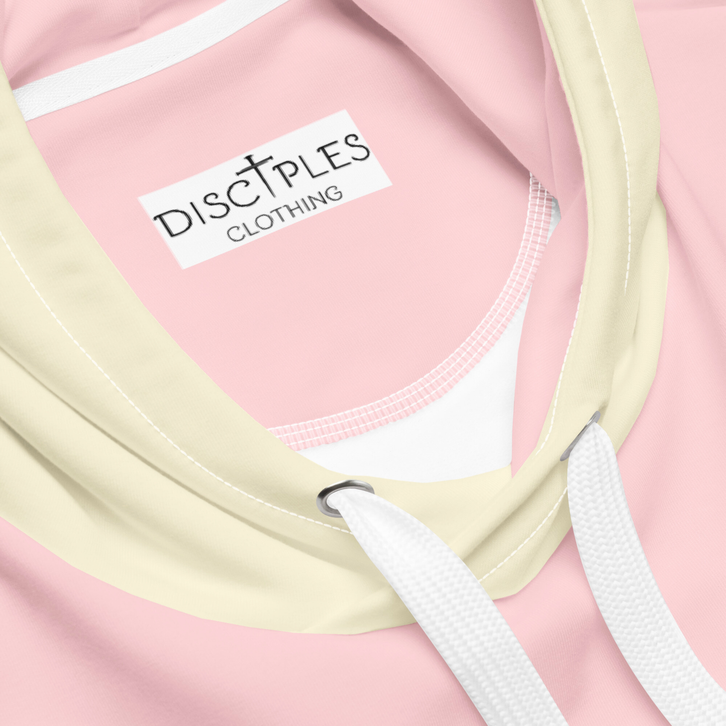 A custom women's color block hoodie with the front and the back of the hoodie being a light pastel pink, the front pocket, both sleeves and the hood are a light ivory in color.