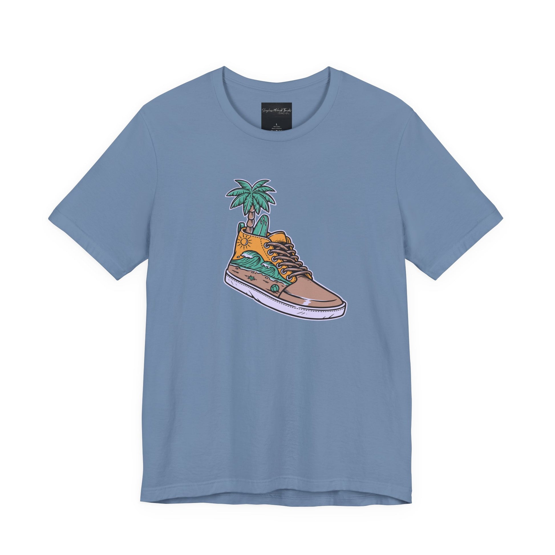 On the front of this custom handmade short sleeve shirt is an image of a high top running shoe with ocean waves running along the side of the shoe, coming out of the top of the shoe where your foot goes is a palm tree and a surf board.