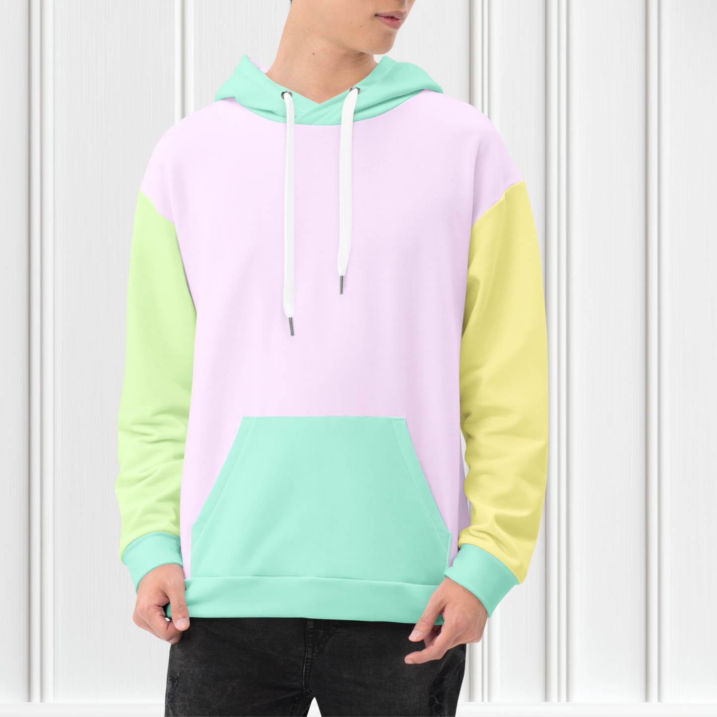 A custom hand sewn unisex hoodie that has a pastel color block design, the front and the back of the sweater are a light purple with the bottom waistband, the front pocket, hood and each cuff is a light mint green, the left sleeve is yellow and the right sleeve is a light grass green.