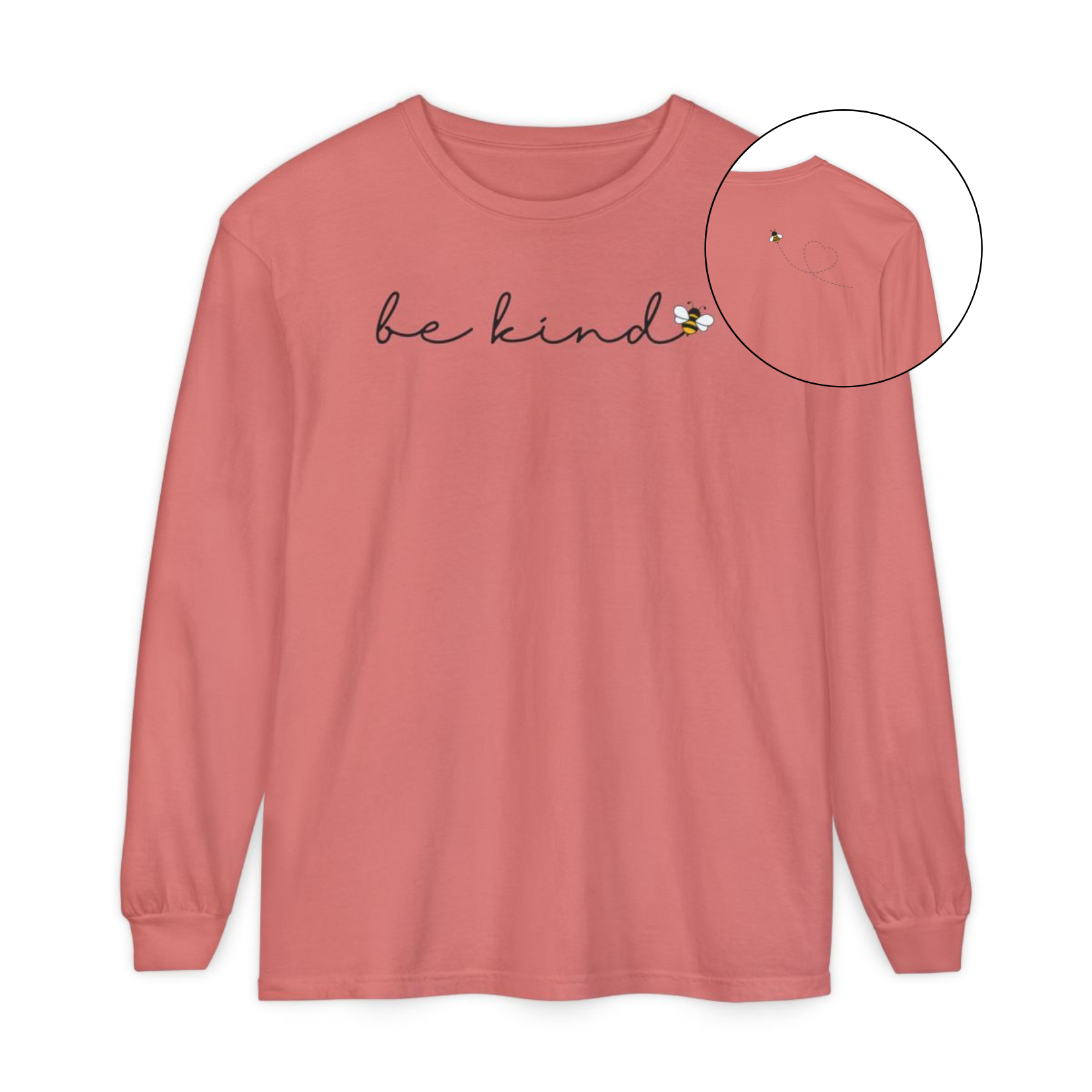 On the front of this custom unisex long sleeve shirt are the words be kind in a simple cursive font, with a bumble bee on the right side of the letter kind, on the back right shoulder there is an image of a bumble bee flying and leaving a trail behind it in the shape of a heart.