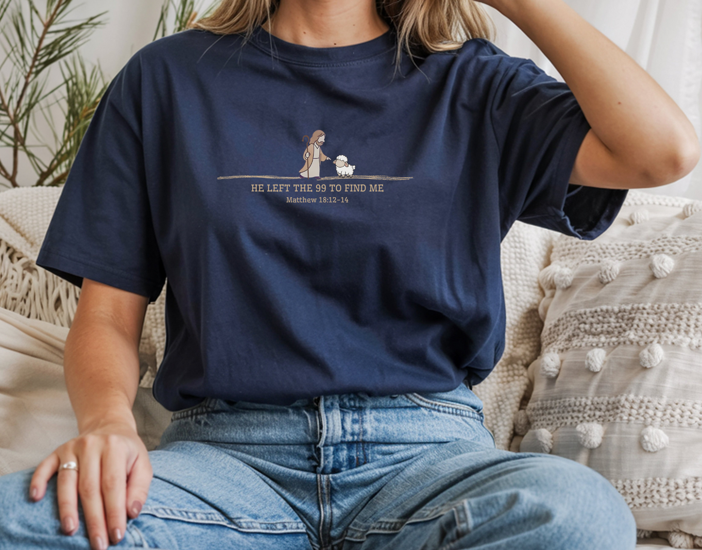 On the front of this custom Christian t-shirt is an image of Jesus the shepherd standing next to a little lamb, underneath the image are the words He left the 99 to Rescue Me Matthew 18:12-14.