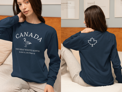 This custom Canadian made unisex long sleeve t-shirt features a Canadian goose on the front in the center of the shirt with the words 'Canada'  above it and 'The Great White North' under the goose, on the back left shoulder blade of the long sleeve shirt is a maple leaf.