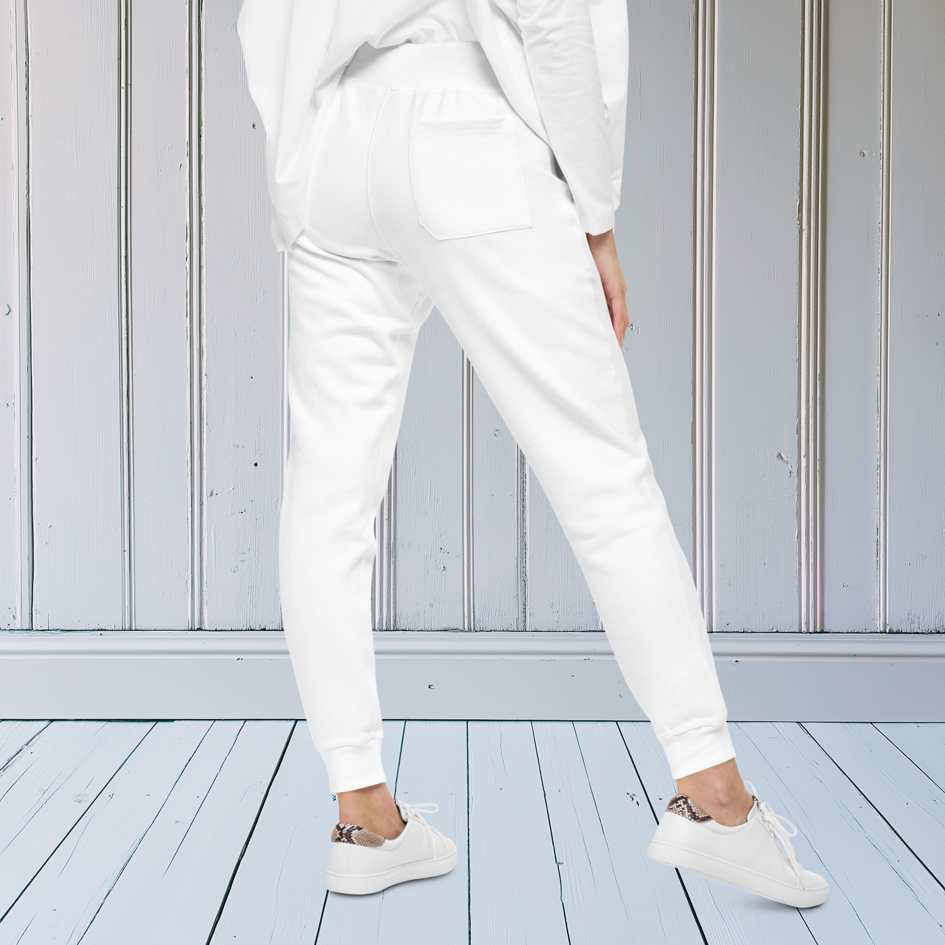 A pair of super soft ankle length unisex sweatpants, there are two pockets on the front and one pocket on the back right. There is a red heart with an exclamation point next to it embroidered on the front left pocket.