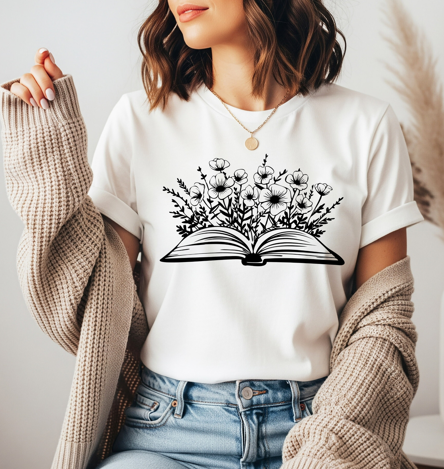 On the front of this custom women's book lover shirt is a image of a book with it opened in the middle, there are a bunch of wildflowers coming out of the center of the book.