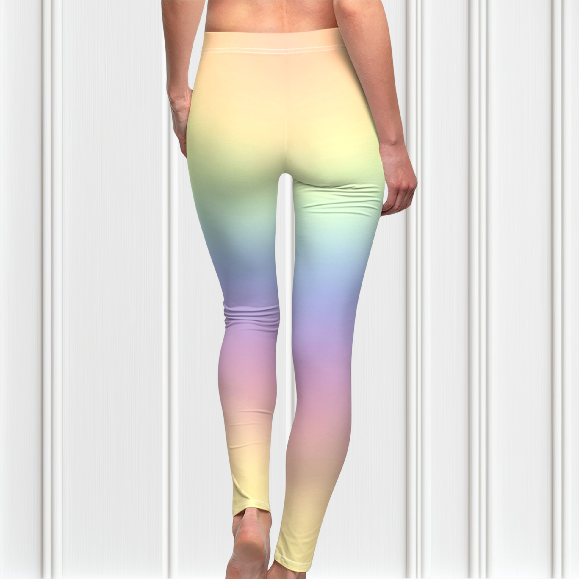A pair of custom women's high waisted leggings with a soft gradient rainbow pattern all over the pants from top to bottom.
