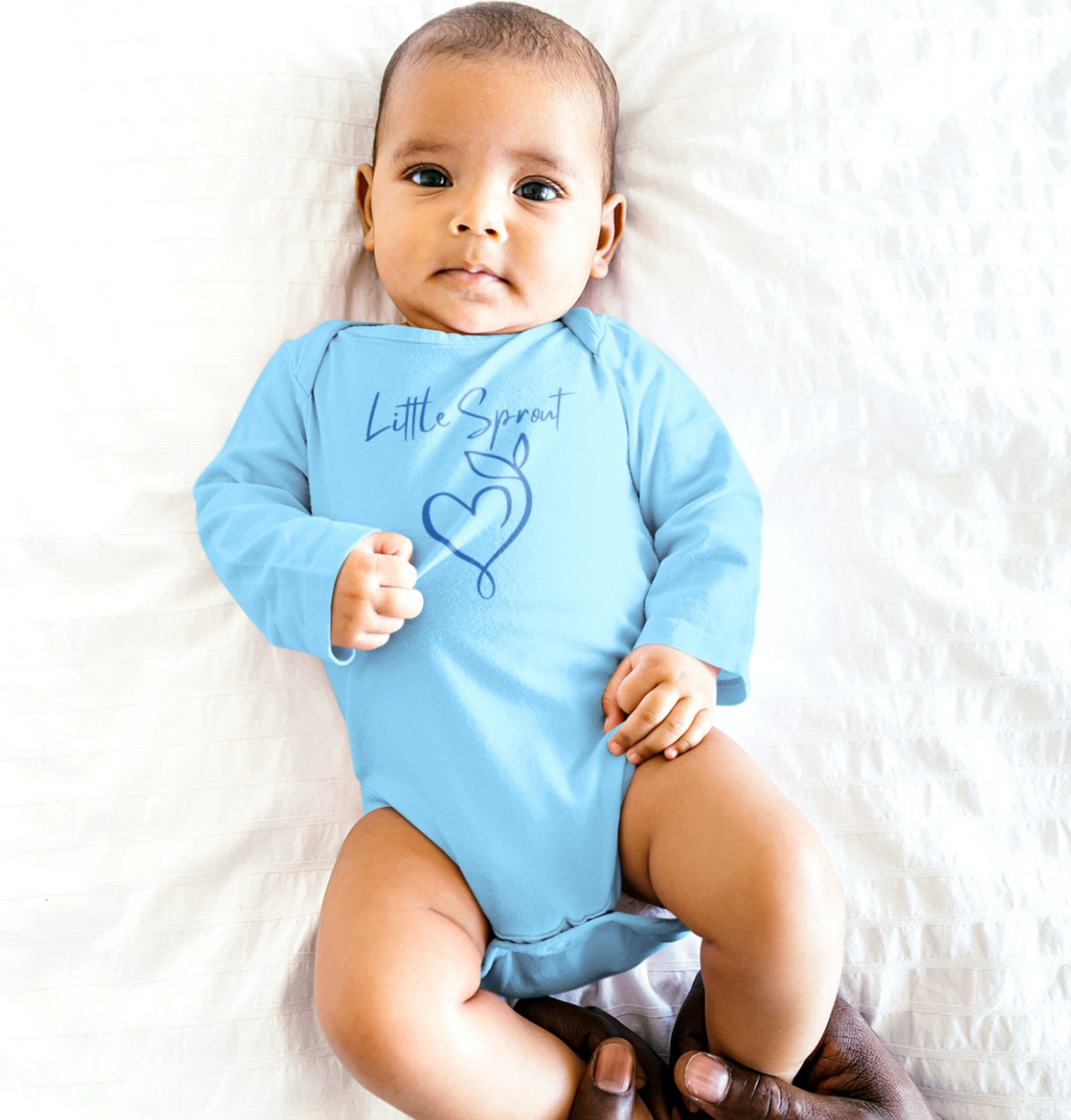 This adorable super soft infant onesie features the words 'little sprout' with a heart and two leaf stem design on the front, creating a cute and playful vibe.