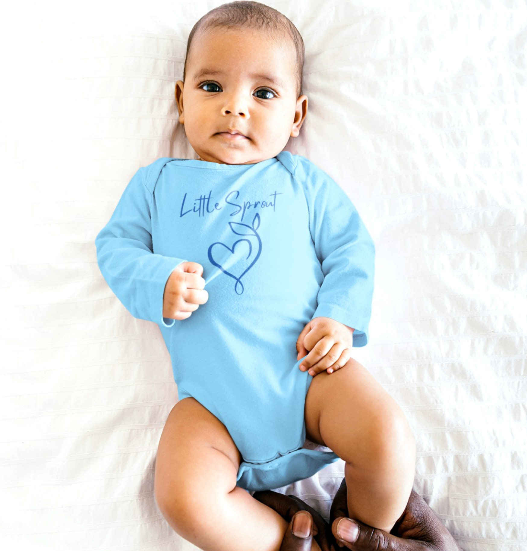 This adorable super soft infant onesie features the words 'little sprout' with a heart and two leaf stem design on the front, creating a cute and playful vibe.