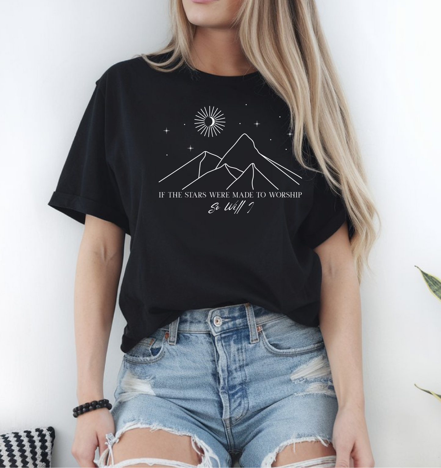 On the front of this custom Christian short sleeve shirt is a line drawing of mountains, and a moon and stars above the mountains, underneath the image are the words If the stars were made to worship so will I.
