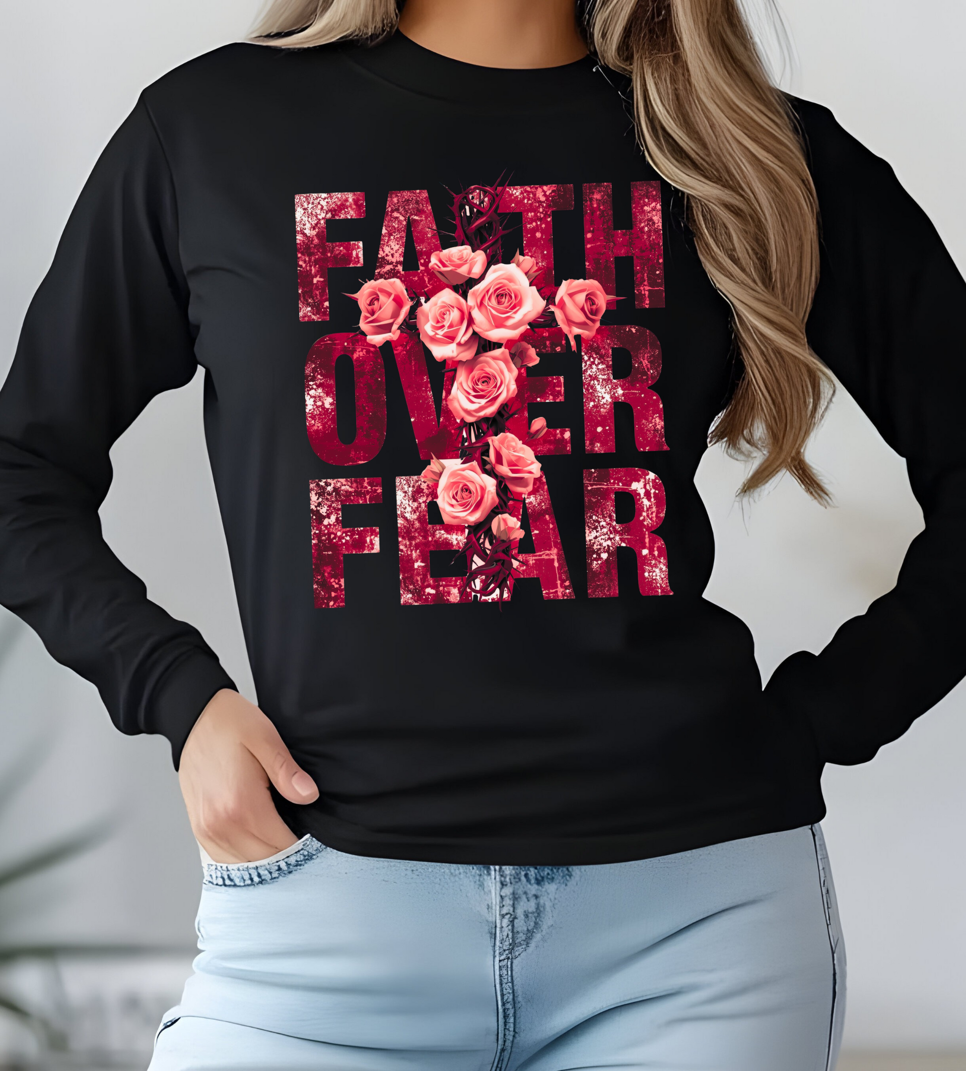 On the front of this Christian vintage long sleeve shirt are the words Faith Over Fear in large block letters with a cross made of thorns in the middle that is covered in roses.