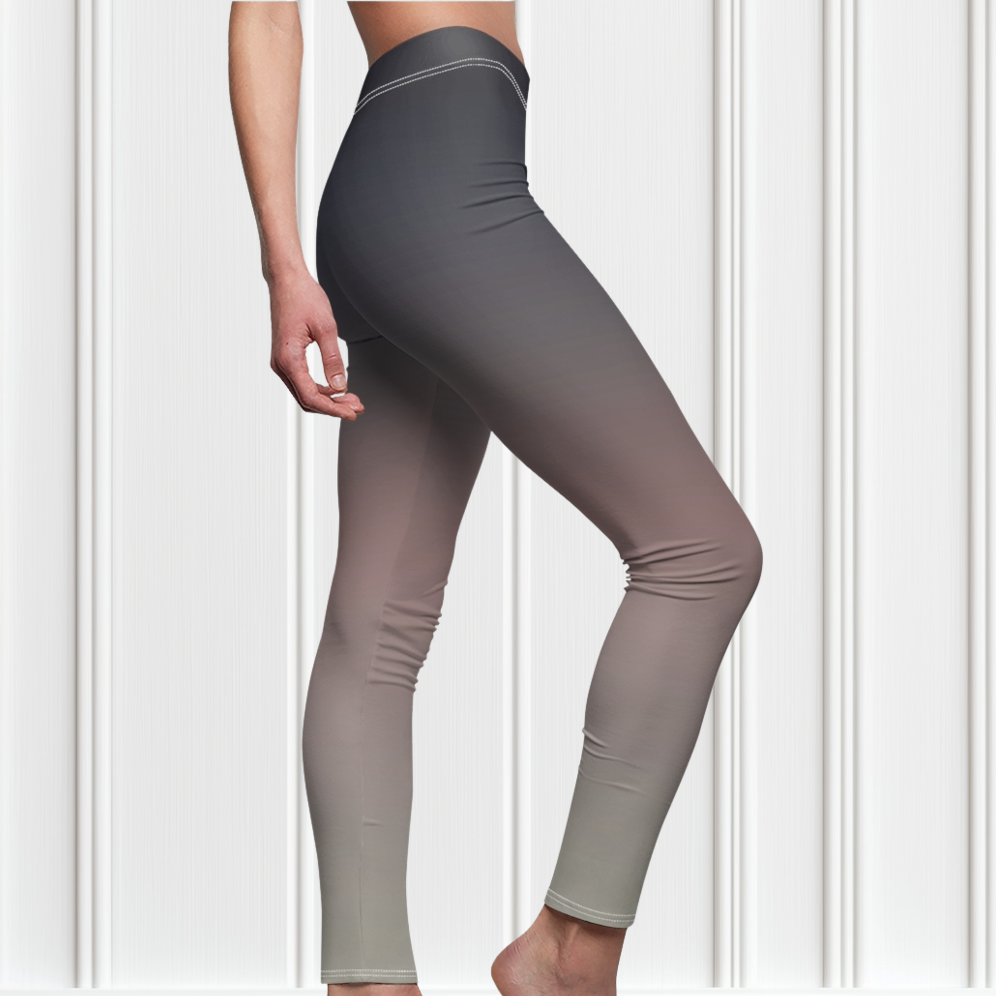 A pair of women's custom high waisted leggings that have an ombre pattern that starts as black at the top of the leggings then fades to a light pink in the middle then to a beige at the bottom of the pants.