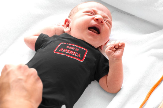 On the front of this custom baby onesie are the words Made In America in a rectangular box that makes it look like a stamp, on the back of this bodysuit is the American flag.