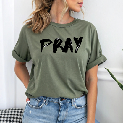 On the front of this custom handmade short sleeve shirt is the word pray in large black lettering, inside each letter in smaller writing are the words For it On it Over it and Through it in a different color font.