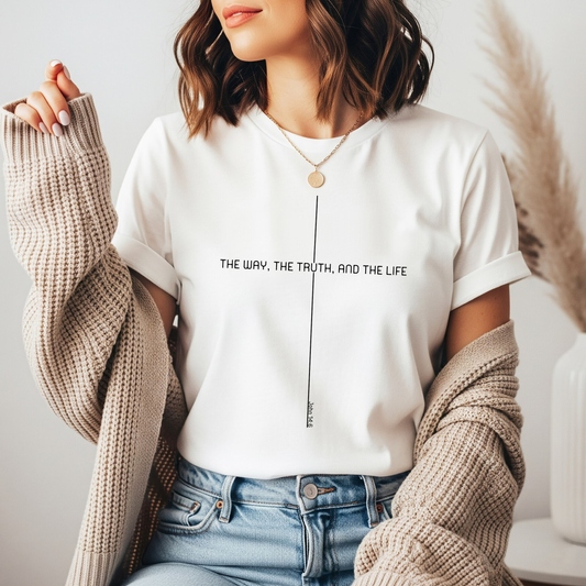 On the front of this custom faith inspired handmade t-shirt is a cross with the bible verse The Way, The Truth, and The Life John 14:6 in a modern font.