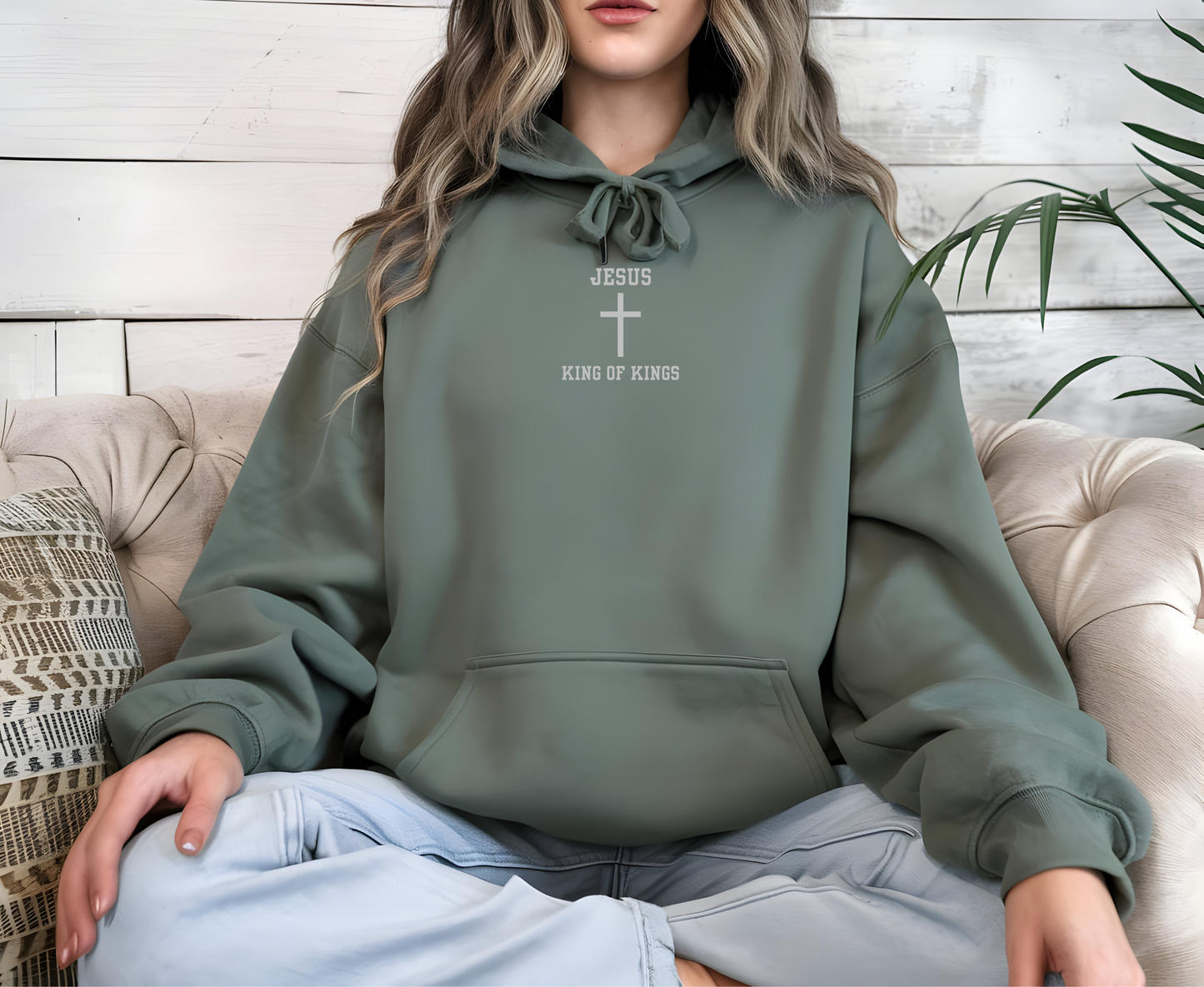 On the front of this custom embroidered unisex hooded sweatshirt are the words Jesus King of Kings with a Jesus cross in the center embroidered into the upper middle of the hoodie in silver thread.