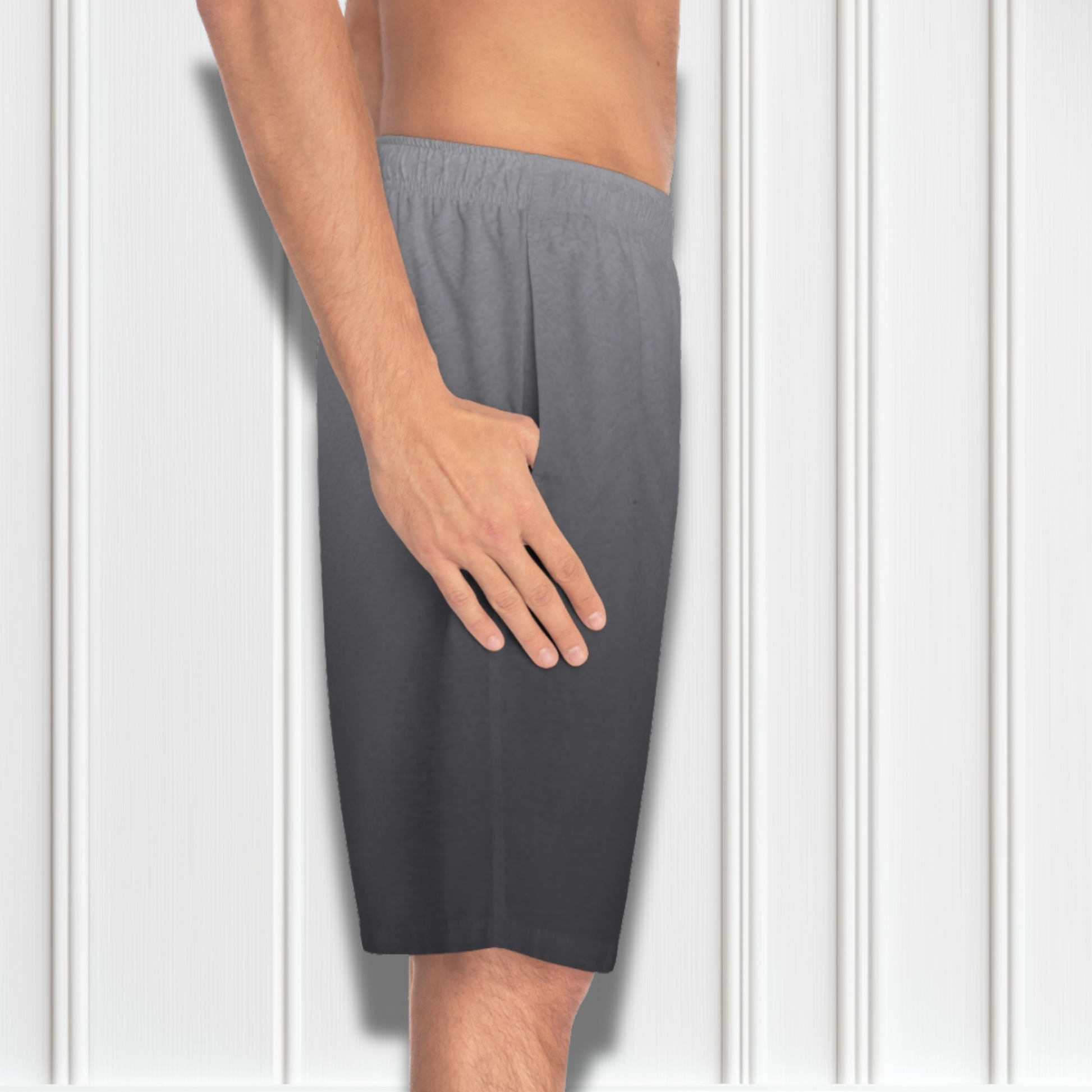 These custom men's board shorts feature a unique design with a ombre pattern starting with a light grey at the top then fading to a dark grey at the bottom, there is a symbol of a dove carrying a fig leaf on the front left side of the shorts just at the knee.