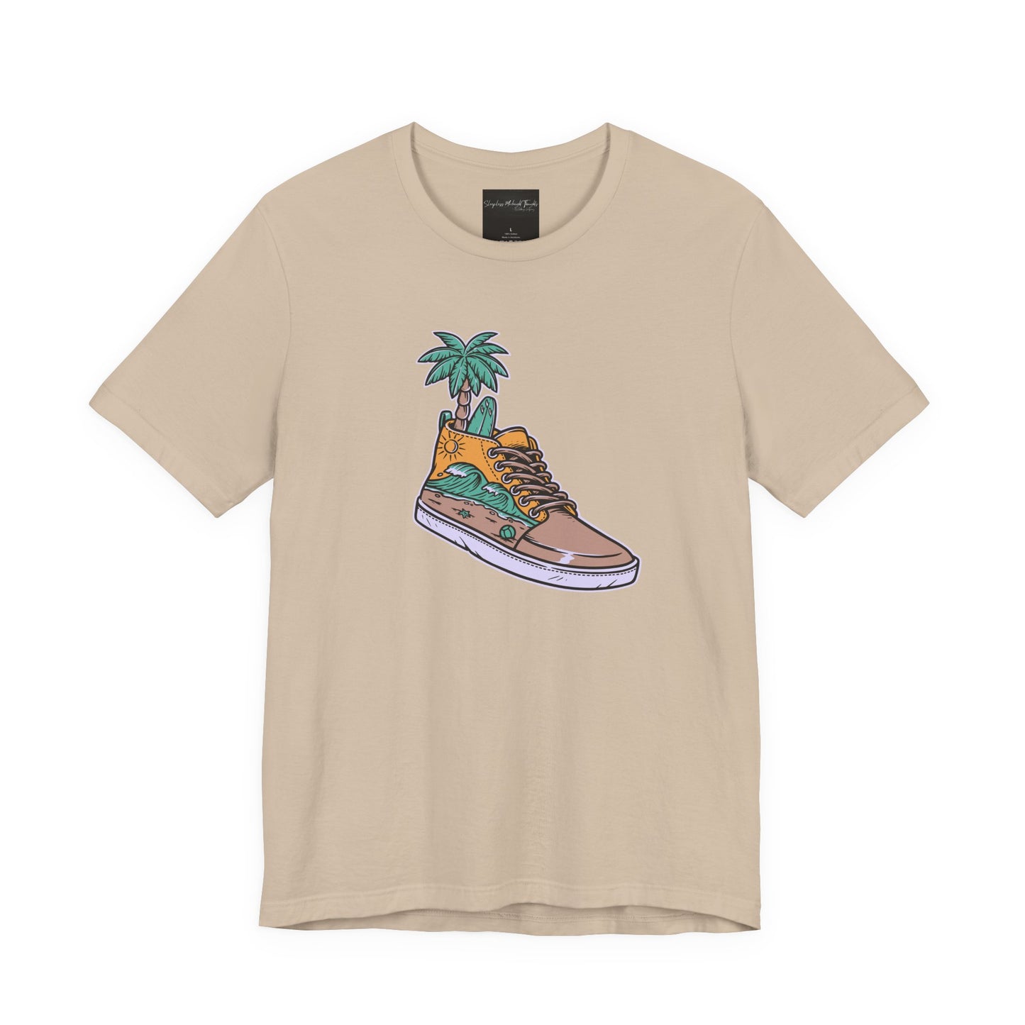 On the front of this custom handmade short sleeve shirt is an image of a high top running shoe with ocean waves running along the side of the shoe, coming out of the top of the shoe where your foot goes is a palm tree and a surf board.