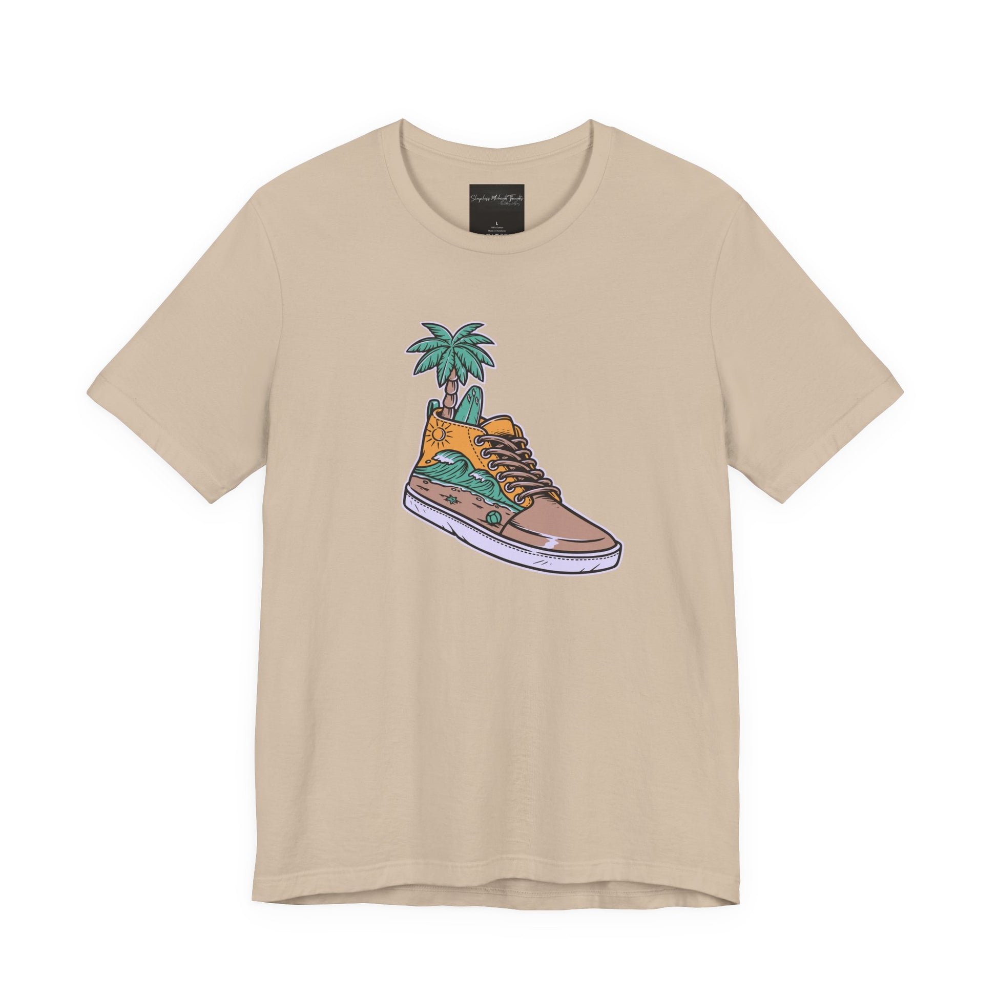 On the front of this custom handmade short sleeve shirt is an image of a high top running shoe with ocean waves running along the side of the shoe, coming out of the top of the shoe where your foot goes is a palm tree and a surf board.
