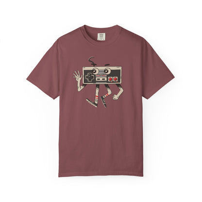 On the front of this custom vintage gaming short sleeve shirt is an image of a old school Nintendo controller, the controller has arms and legs and a face that makes it look like a cartoon character.