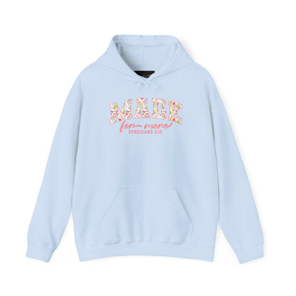 On the front of this custom Christian hoodie is the bible verse the says Made for more Ephesians 2:10, with the word "Made" being large block letters with a pink floral pattern inside the letters, all the other words are in a light pink color.
