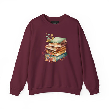 On the front of this custom book lovers sweatshirt is a stack of vintage books with a bunch of wildflowers all around the books.