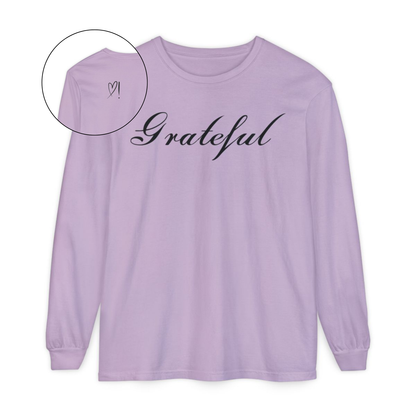 On the front of this custom long sleeve t-shirt in cursive writing is the word grateful on the upper chest, on the back left shoulder blade is an image of a heart with an exclamation mark next to it.