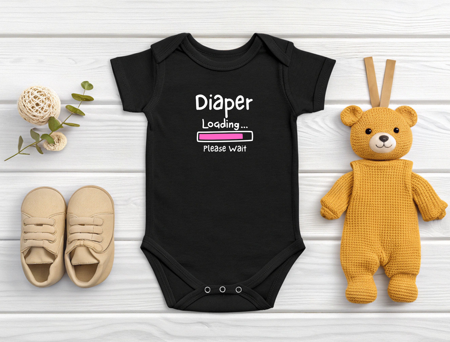 On the front of this custom infant onesie are the words Diaper loading please wait with an image of a battery life bar in pink.