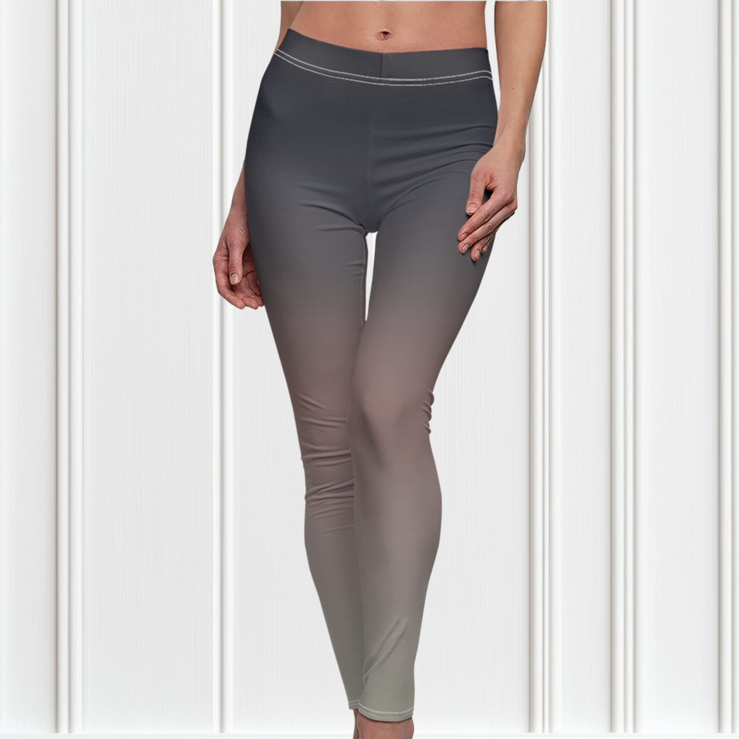 A pair of women's custom high waisted leggings that have an ombre pattern that starts as black at the top of the leggings then fades to a light pink in the middle then to a beige at the bottom of the pants.