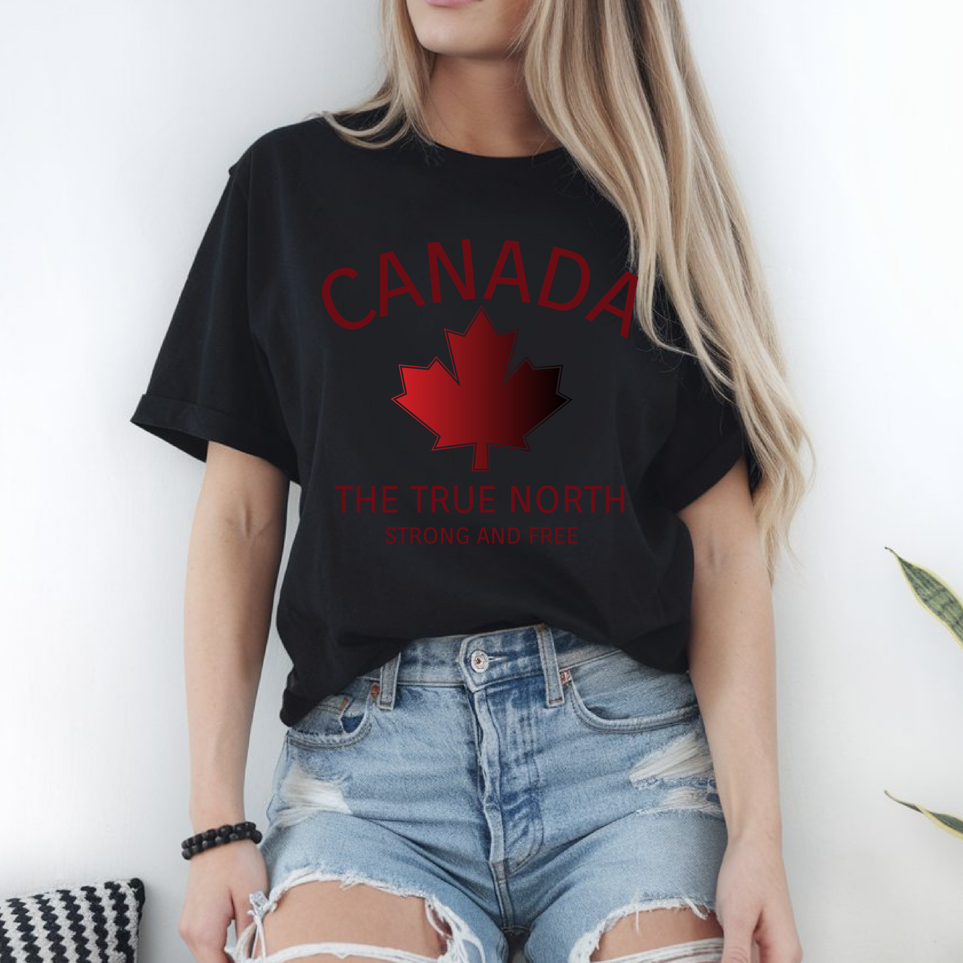 This custom Canadian made unisex custom t-shirt features the words Canada and The true North Strong And Free along with a maple leaf design in red, giving off a patriotic and Canadian vibe.