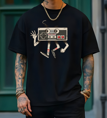 On the front of this custom vintage gaming short sleeve shirt is an image of a old school Nintendo controller, the controller has arms and legs and a face that makes it look like a cartoon character.