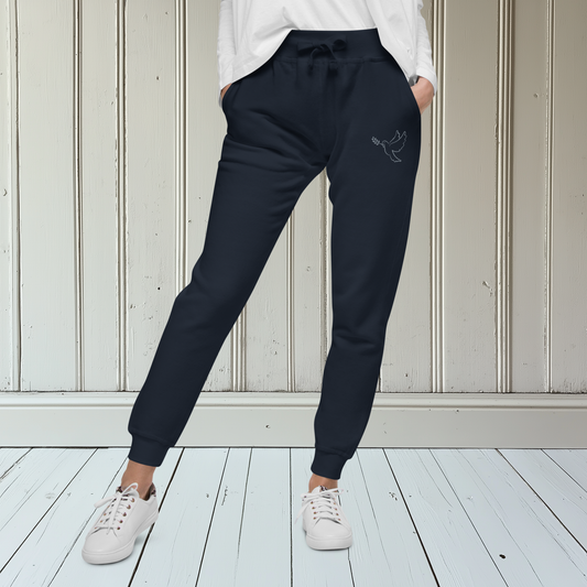 A pair of super soft ankle length unisex Christian sweatpants, there are two pockets on the front and one pocket on the back right, on the front left pocket  there is an embroidered dove with a fig leaf in silver thread.