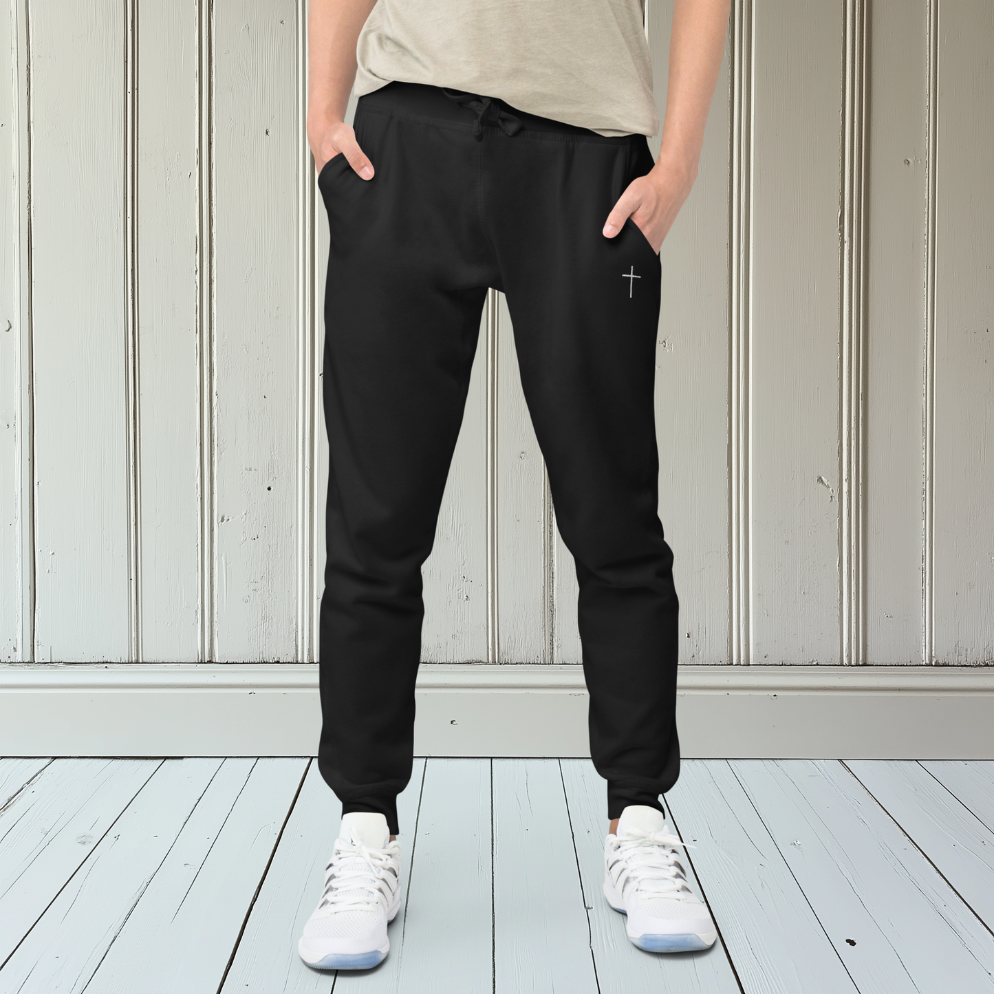 A pair of super soft ankle length Christian unisex sweatpants, there are two pockets on the front and one pocket on the back right, on the front left pocket is a embroidered white cross.