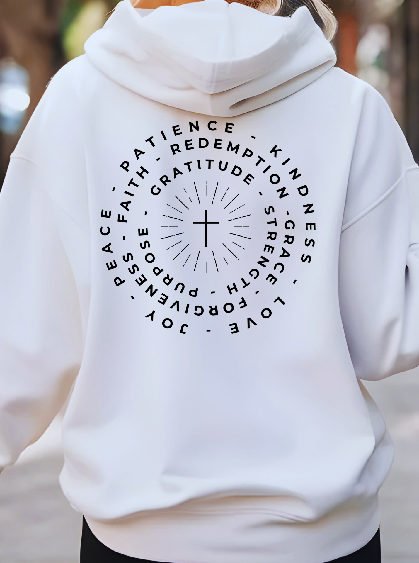This custom Christian hoodie features a unique design on the back with a centered cross surrounded by circles of words such as Gratitude, Redemption, Patience, Joy, Love, Kindness, Peace, Faith, Forgiveness, Grace, Purpose and Strength.