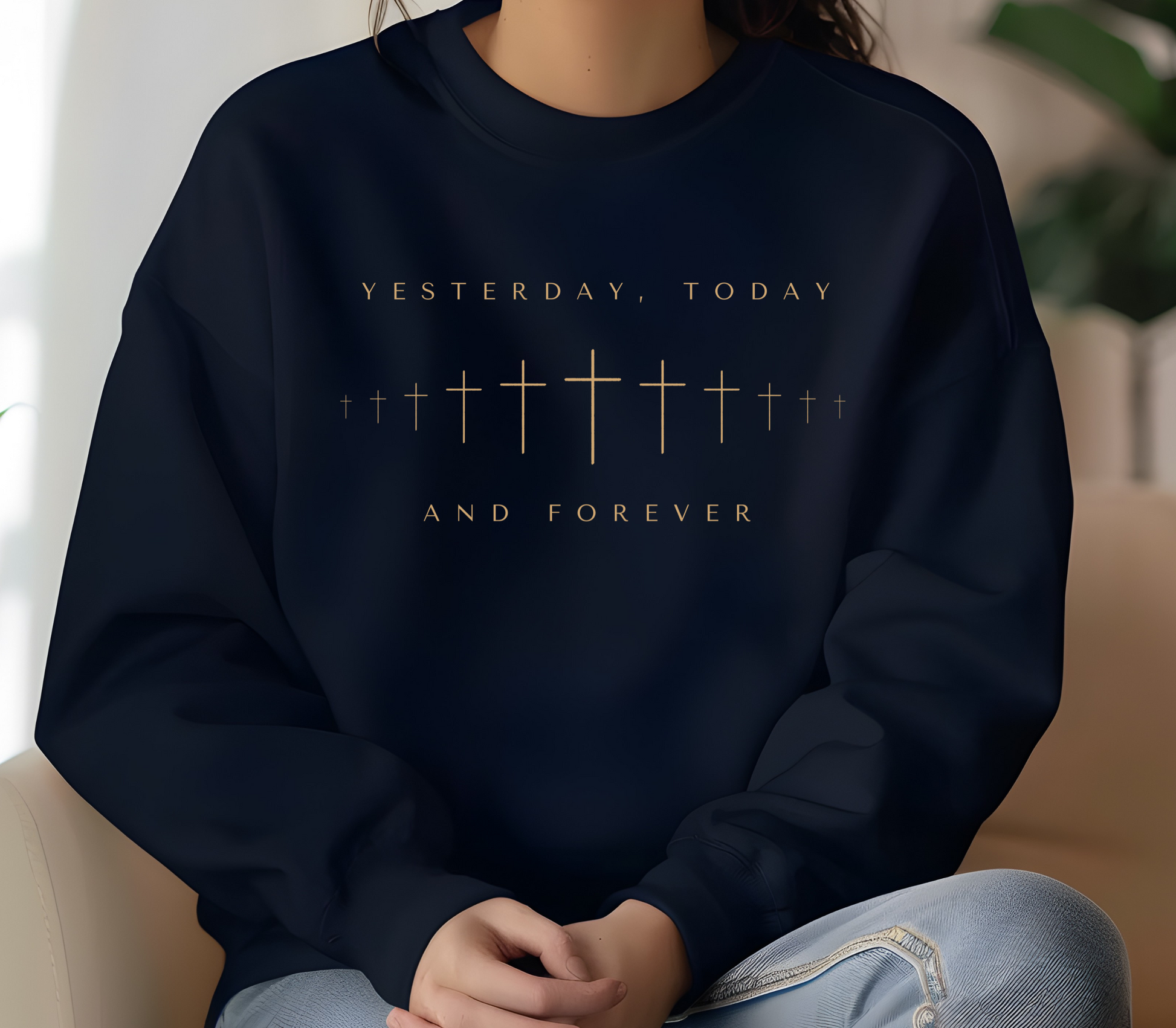 On the front of this Christian pullover sweatshirt is a row of Jesus crosses that look like they are fading into the distance, the words Yesterday, Today and Forever are on the top and the bottom of the crosses.