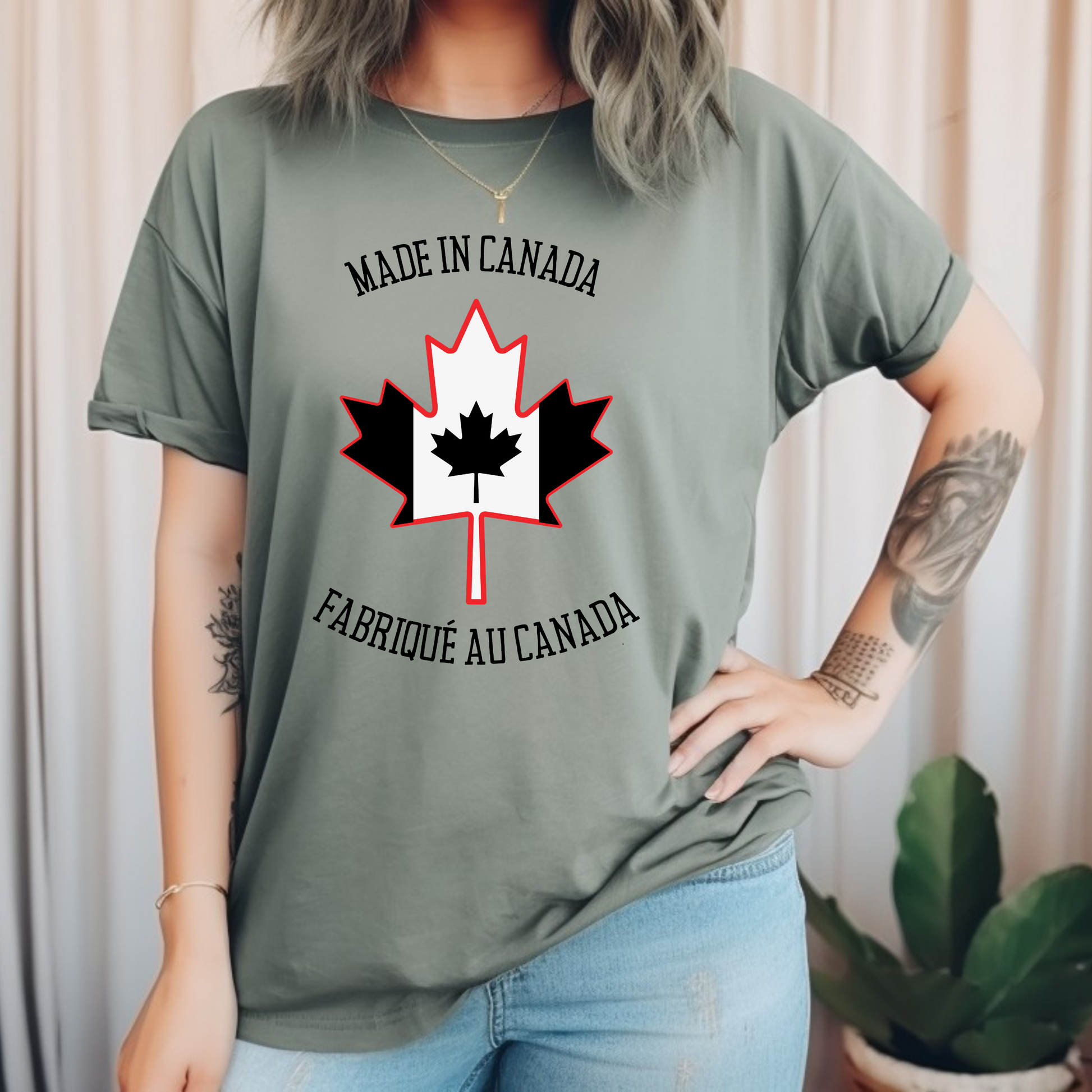 On the front of this custom unisex t-shirt is a large maple leaf with the Canadian flag on the inside, the words Made In Canada are above the maple leaf with the same in French underneath that says Fabrique Au Canada.