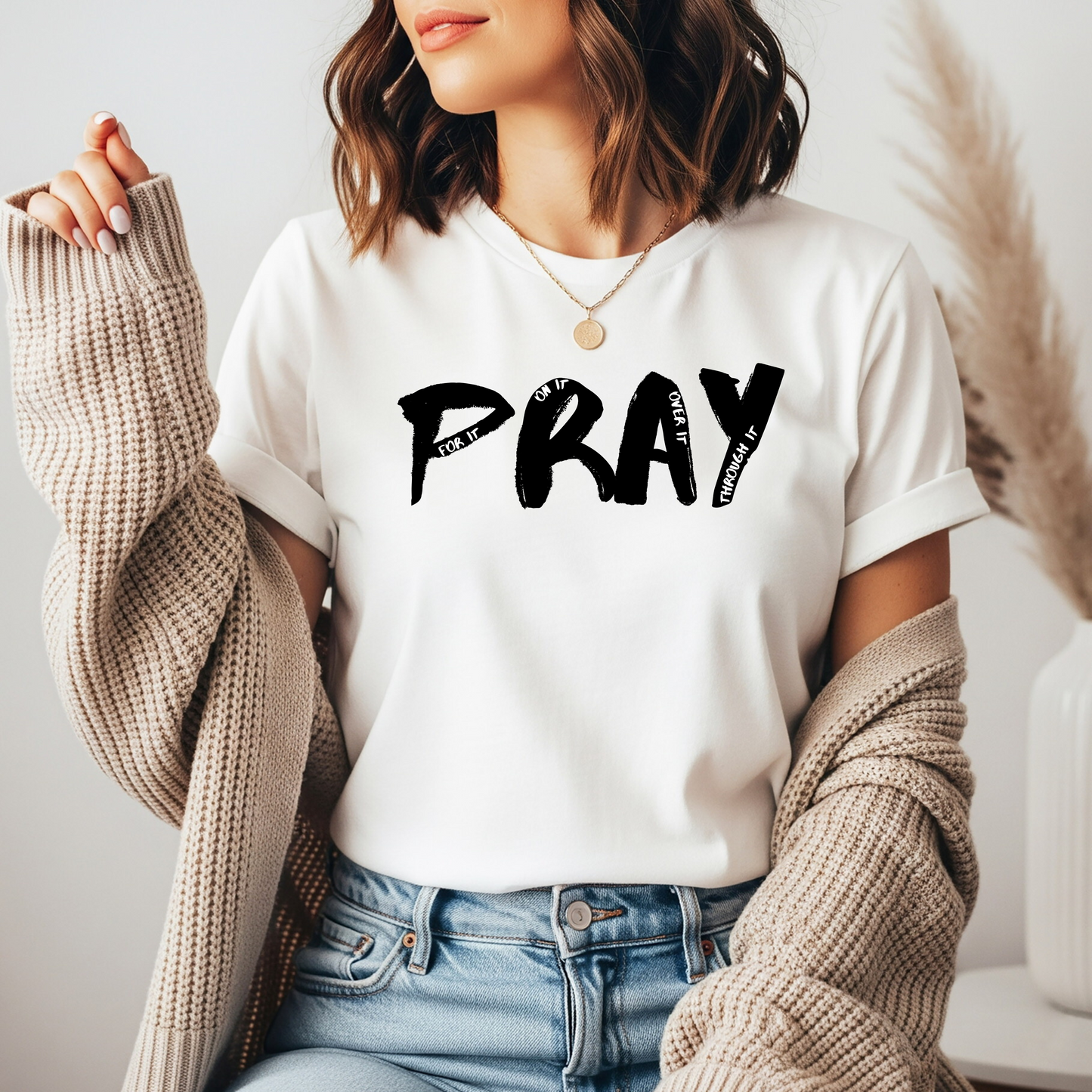 On the front of this custom handmade short sleeve shirt is the word pray in large black lettering, inside each letter in smaller writing are the words For it On it Over it and Through it in a different color font.