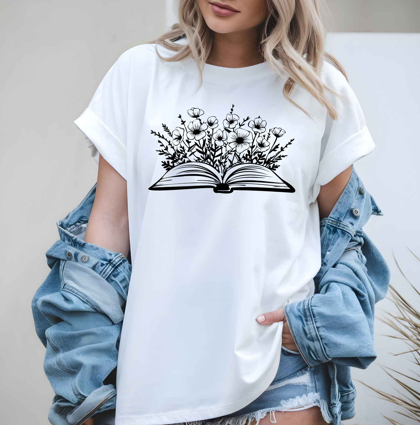 On the front of this custom women's book lover shirt is a image of a book with it opened in the middle, there are a bunch of wildflowers coming out of the center of the book.