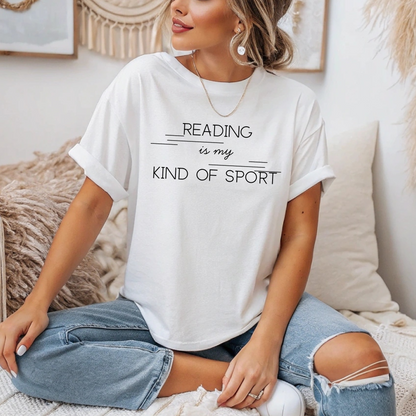 On the front of this custom booklover short sleeve shirt are the words Reading is my Kind of Sport, in a modern font with different length lines on either end of the writing giving the shirt a retro look.