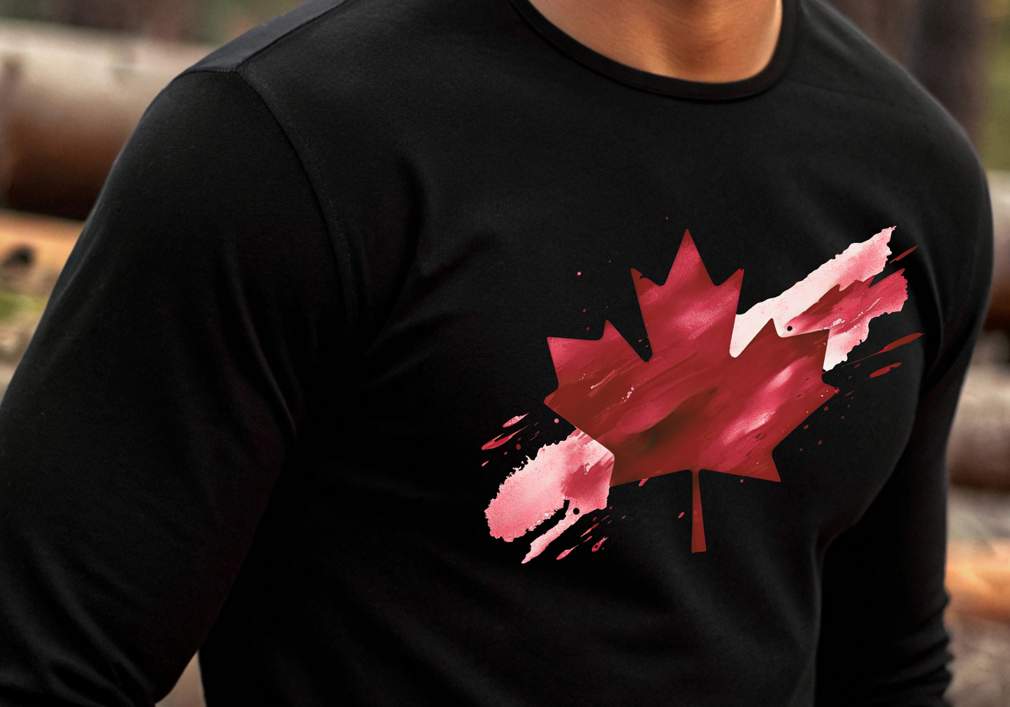 On the front of this unisex long sleeve shirt is an image of a Canadian maple leaf that is bright red, it looks like it has been spray painted onto the front of the shirt.